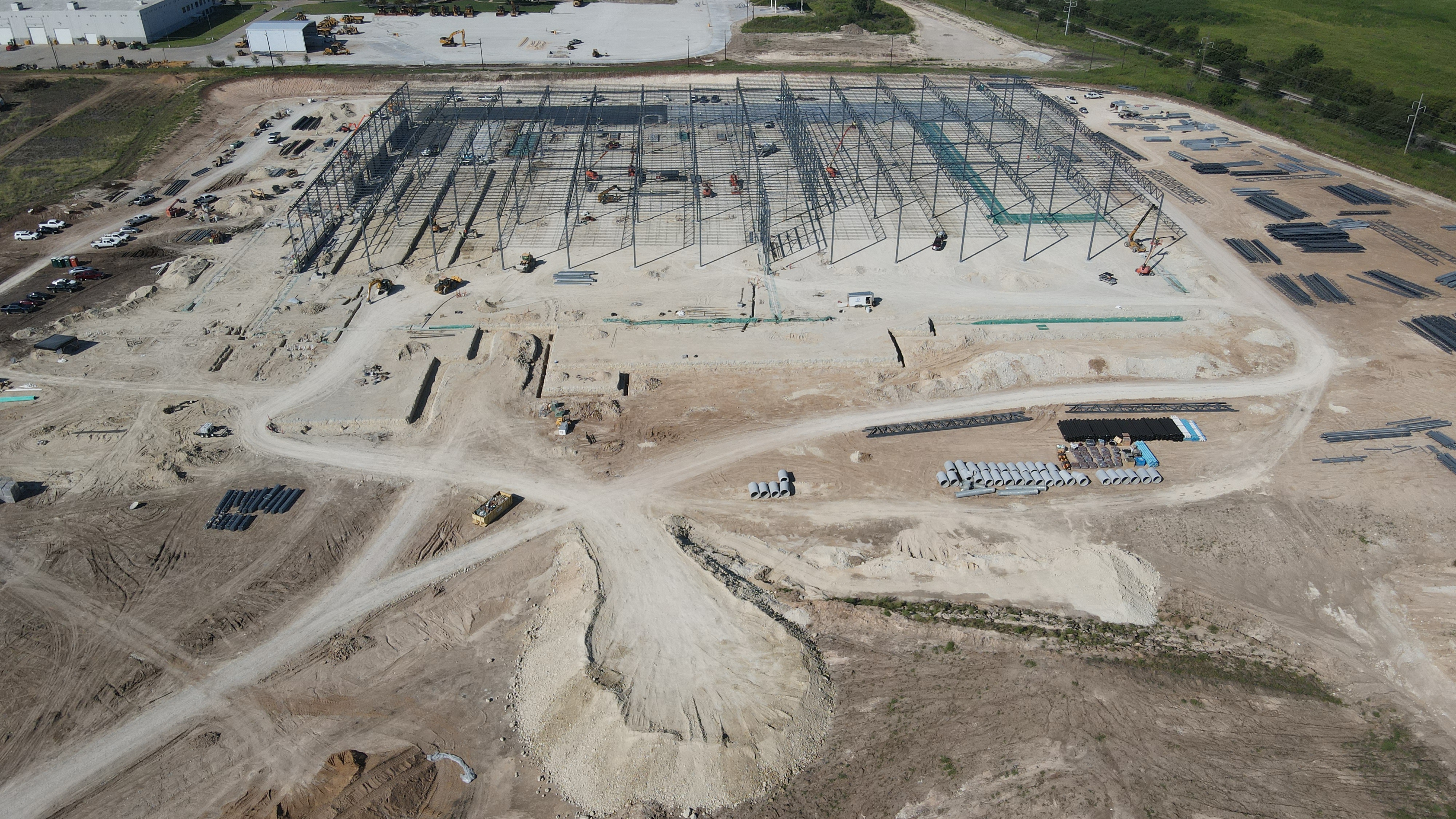 Site prep, utilities, and foundations underway.