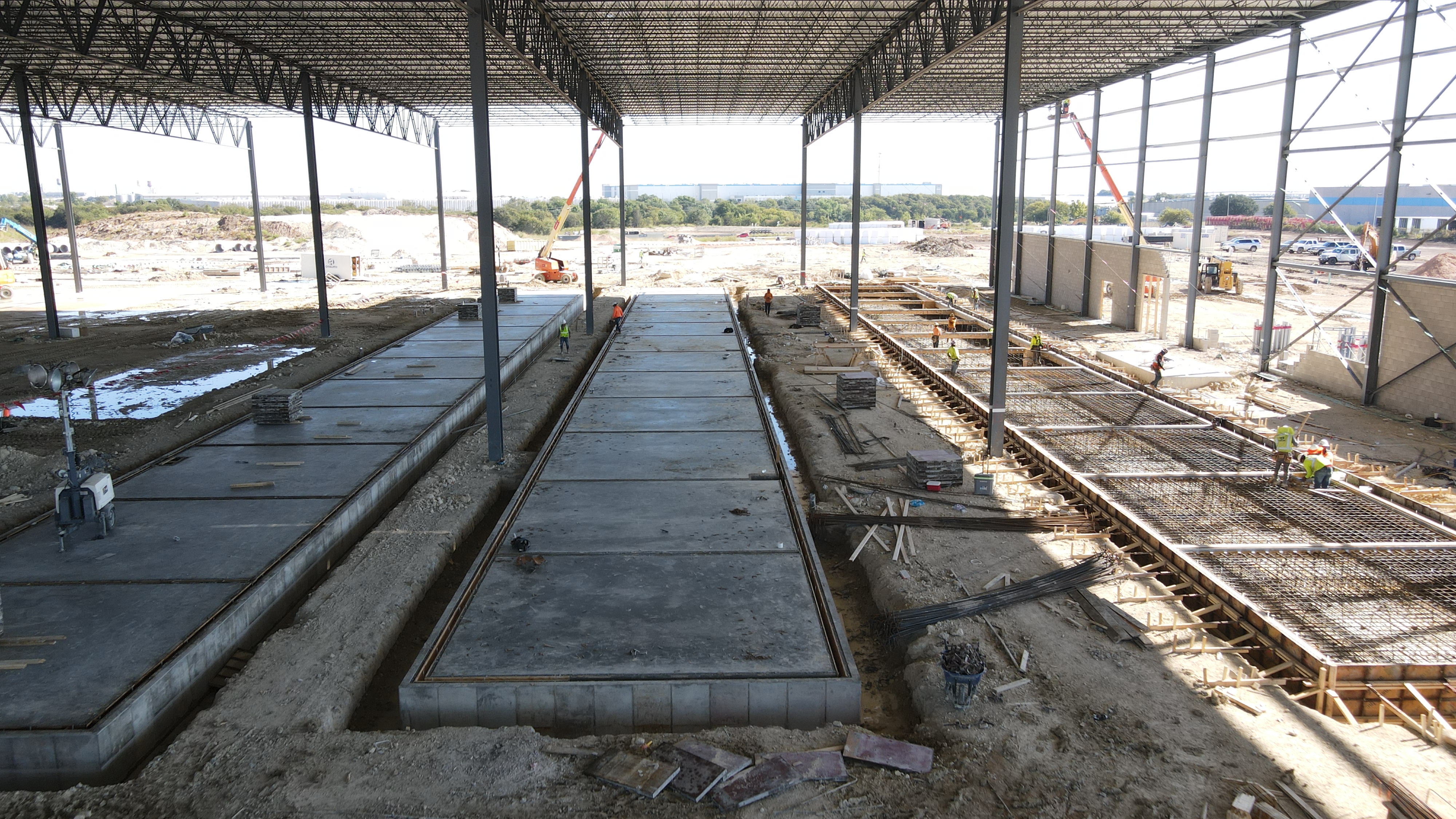 Tilt-up casting beds, scale shown by crew.
