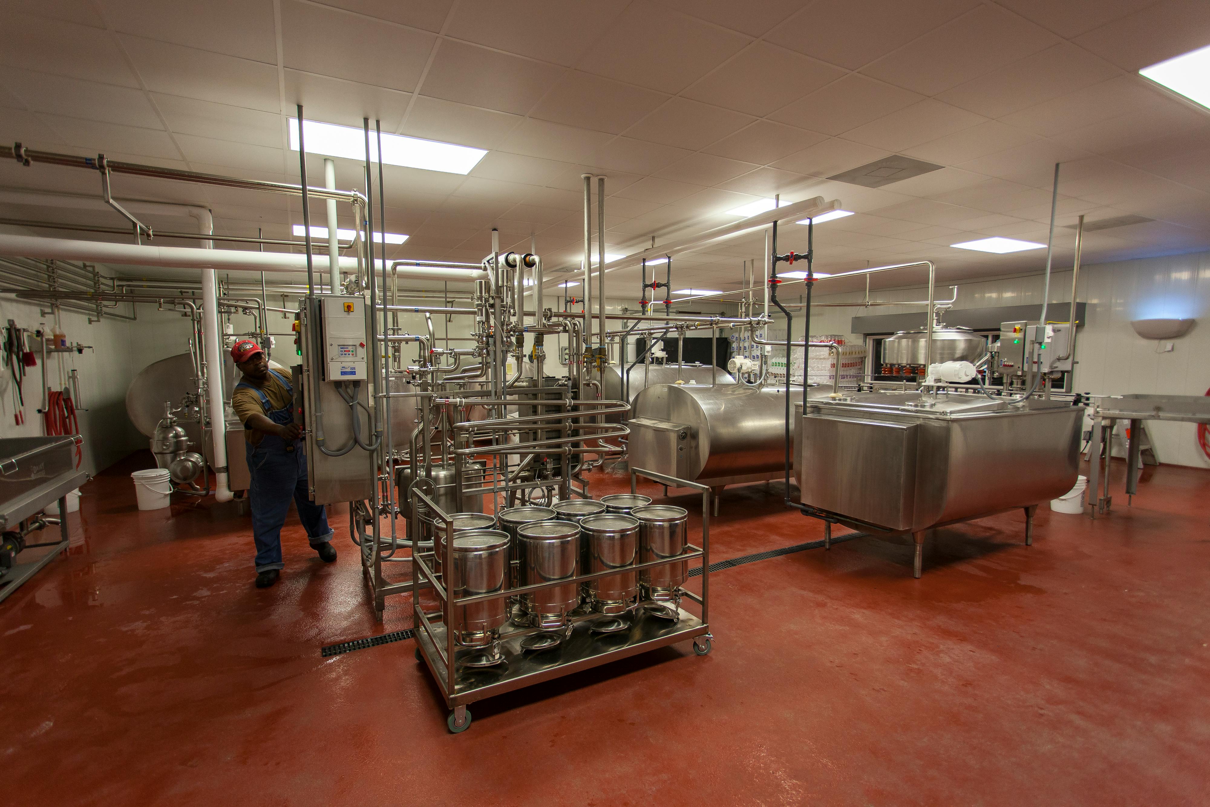 Food processing facility interior with machinery and staff
