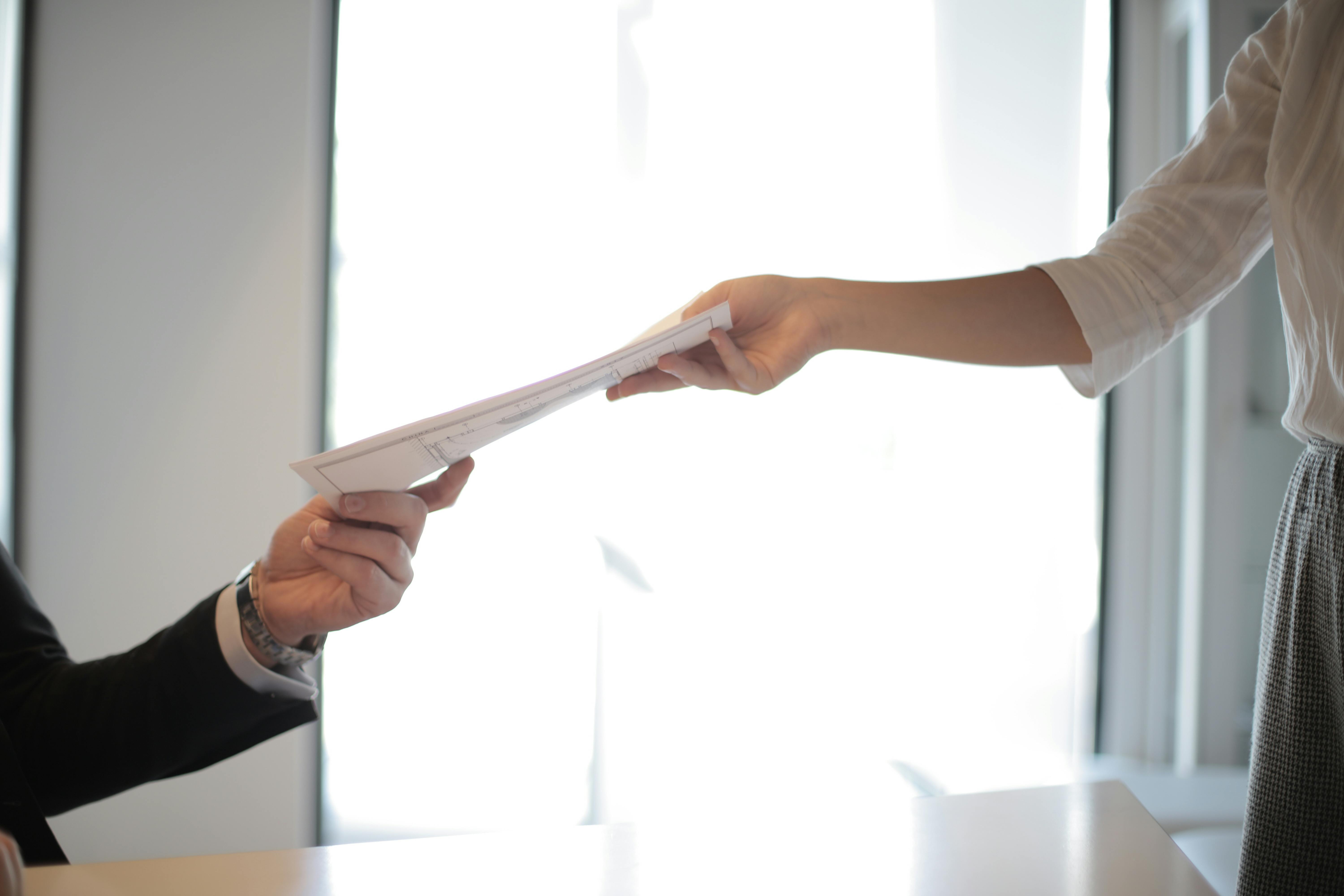 CSC team members exchanging documents in an office environment